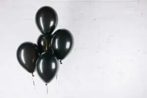 black friday white brick wall black balloons